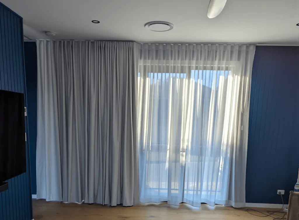 Wave fold curtains installed across a sliding door