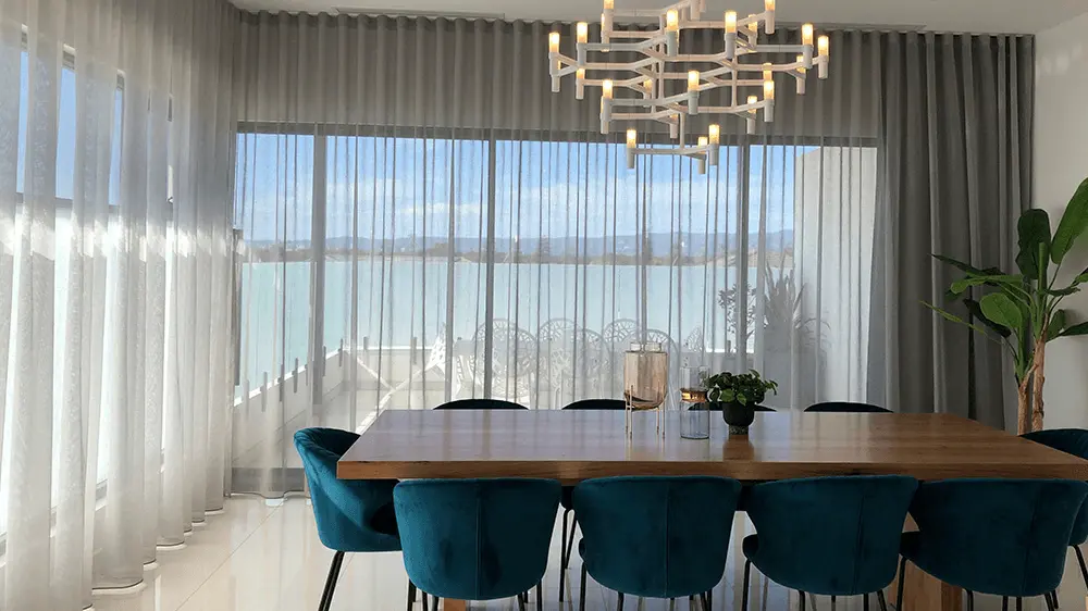 Full-height sheer curtains in a dining space