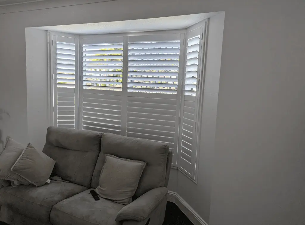 Plantation shutters fitted to a bay window